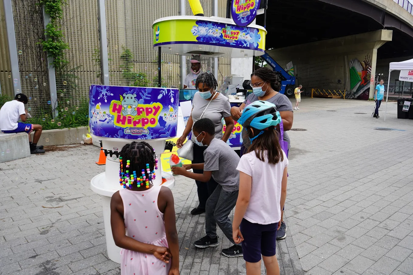 Children and adults enjoying the Happy Hippo mobile cart